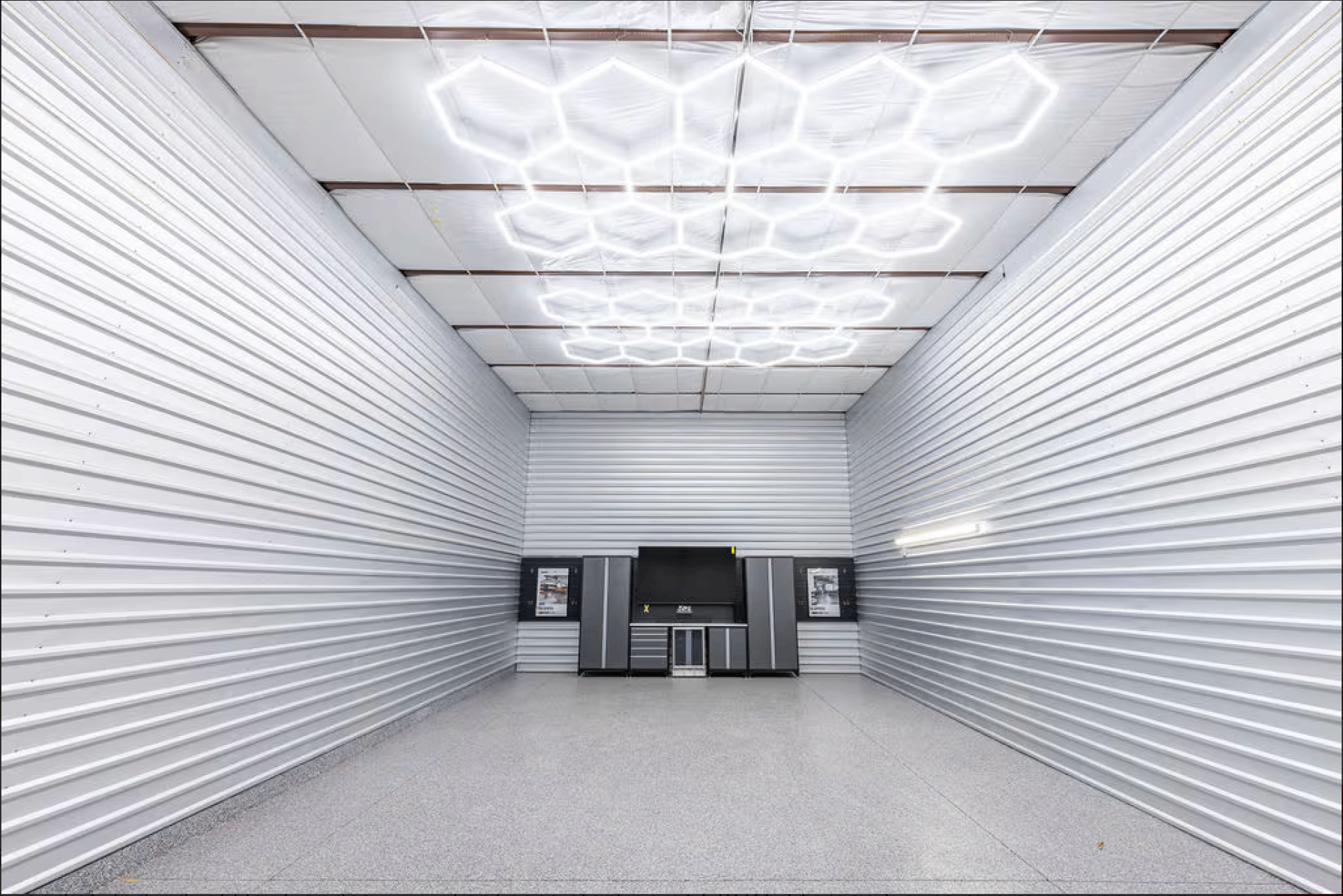 Interior of a Storage Caves garage condo with hexagon LED lighting and finished workshop